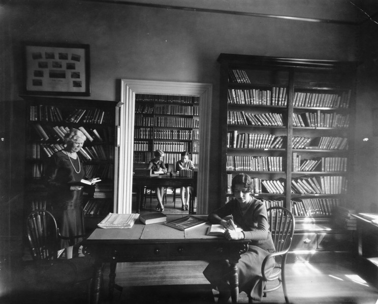 Historic image of female 51Ʒstudents studying in library